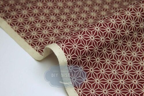Japanese fabric Asanoha ecru on a red background