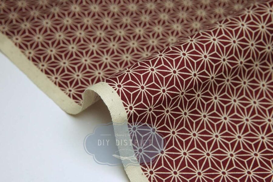 Japanese fabric Asanoha ecru on a red background