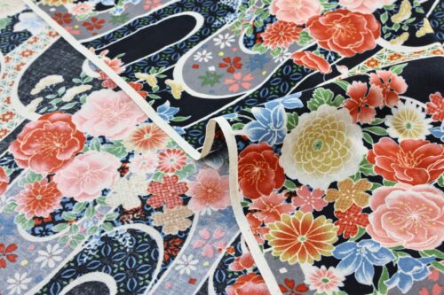 Japanese fabric with flower bouquet on water on black background