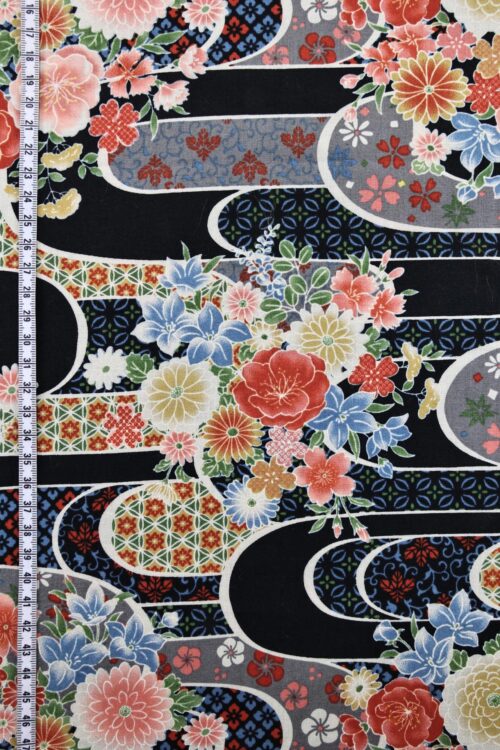 Japanese fabric with flower bouquet on water on black background