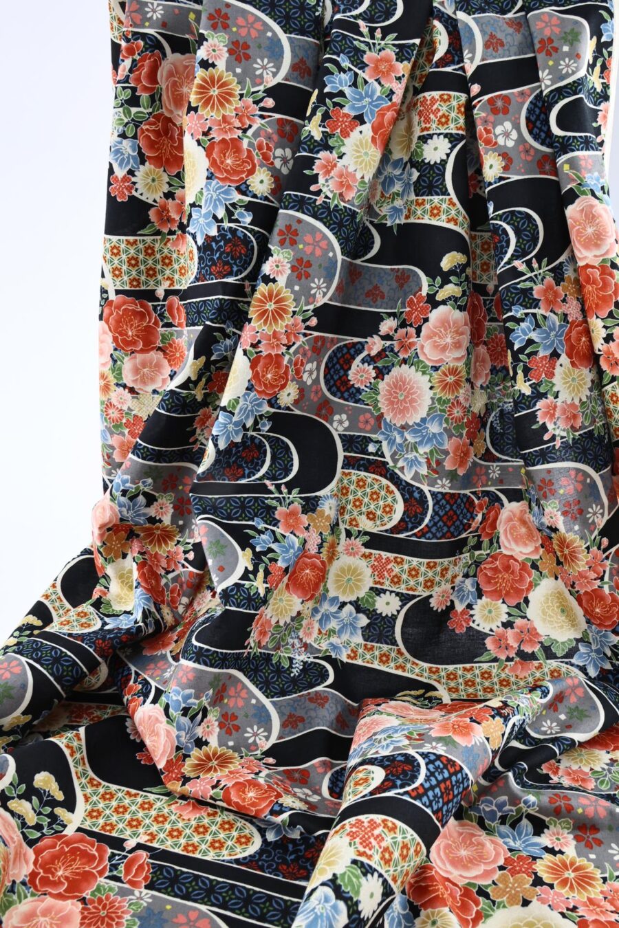 Japanese fabric with flower bouquet on water on black background