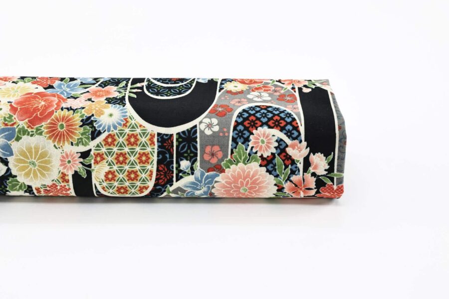 Japanese fabric with flower bouquet on water on black background