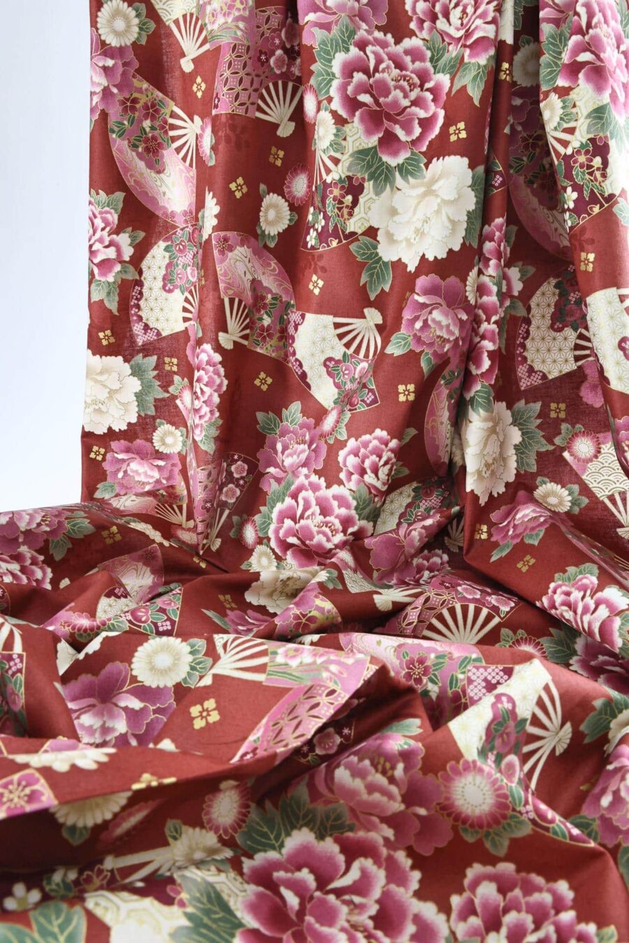 Japanese fabric fans and golden peonies on red