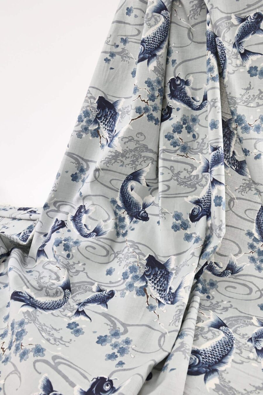 Japanese fabric carps with Sakura on grey background