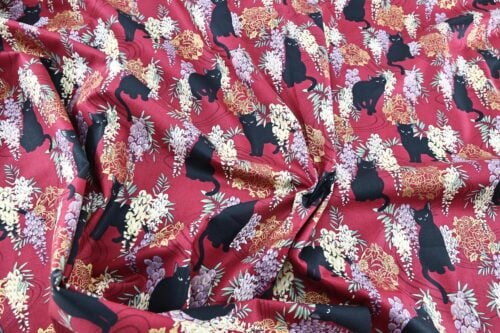 Black cat and Fuji flower fabric red background