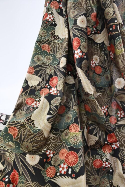 Japanese fabric cranes on golden river