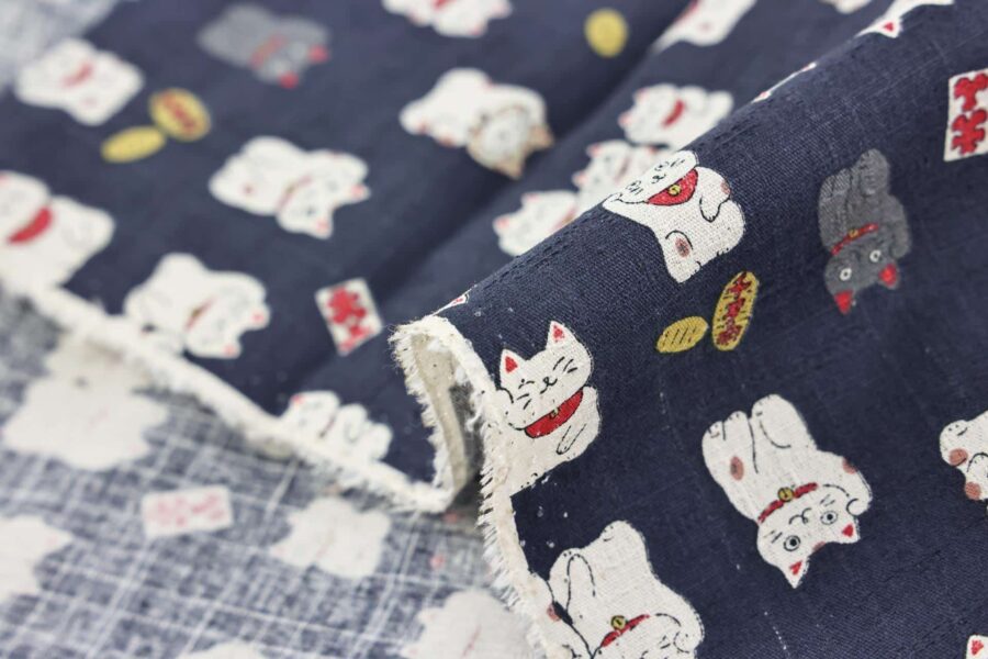 Japanese Maneki Neko dobby cotton fabric – blue background
