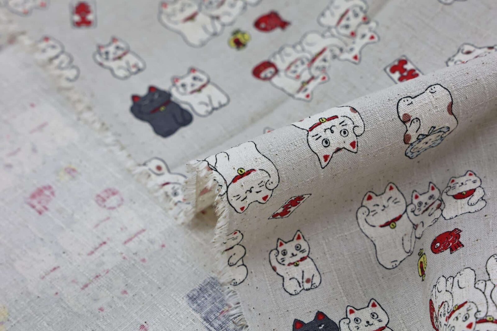 Japanese Maneki Neko dobby cotton fabric – ecru background