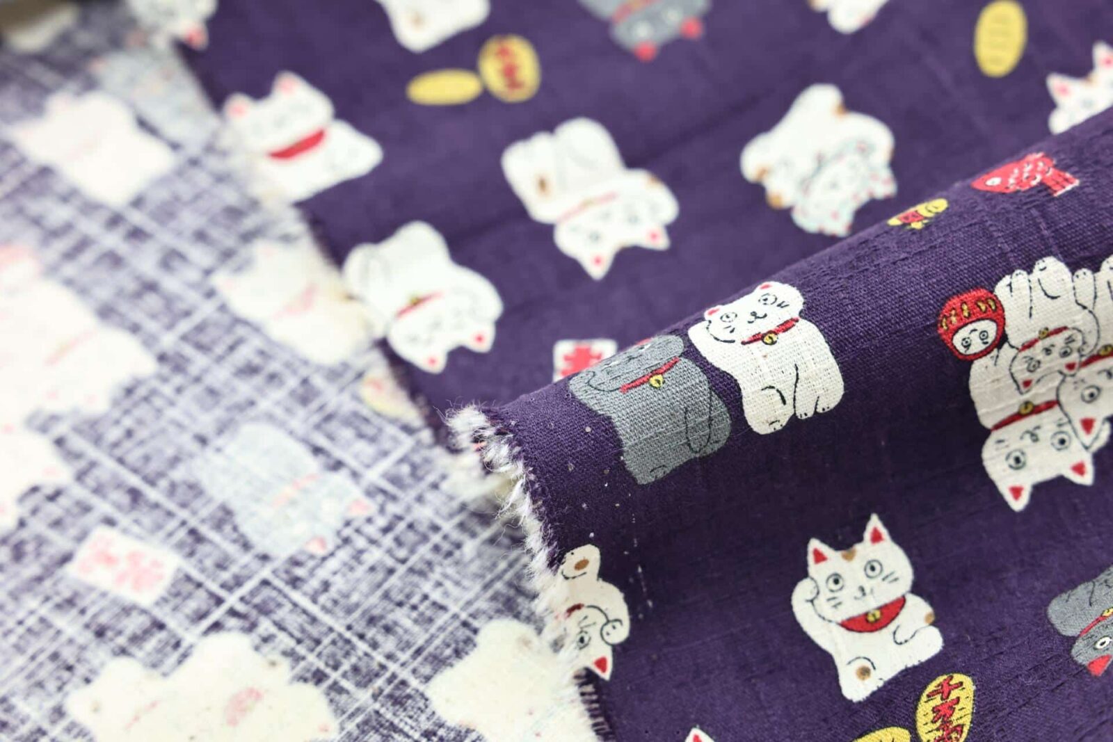 Japanese Maneki Neko dobby cotton fabric – purple background