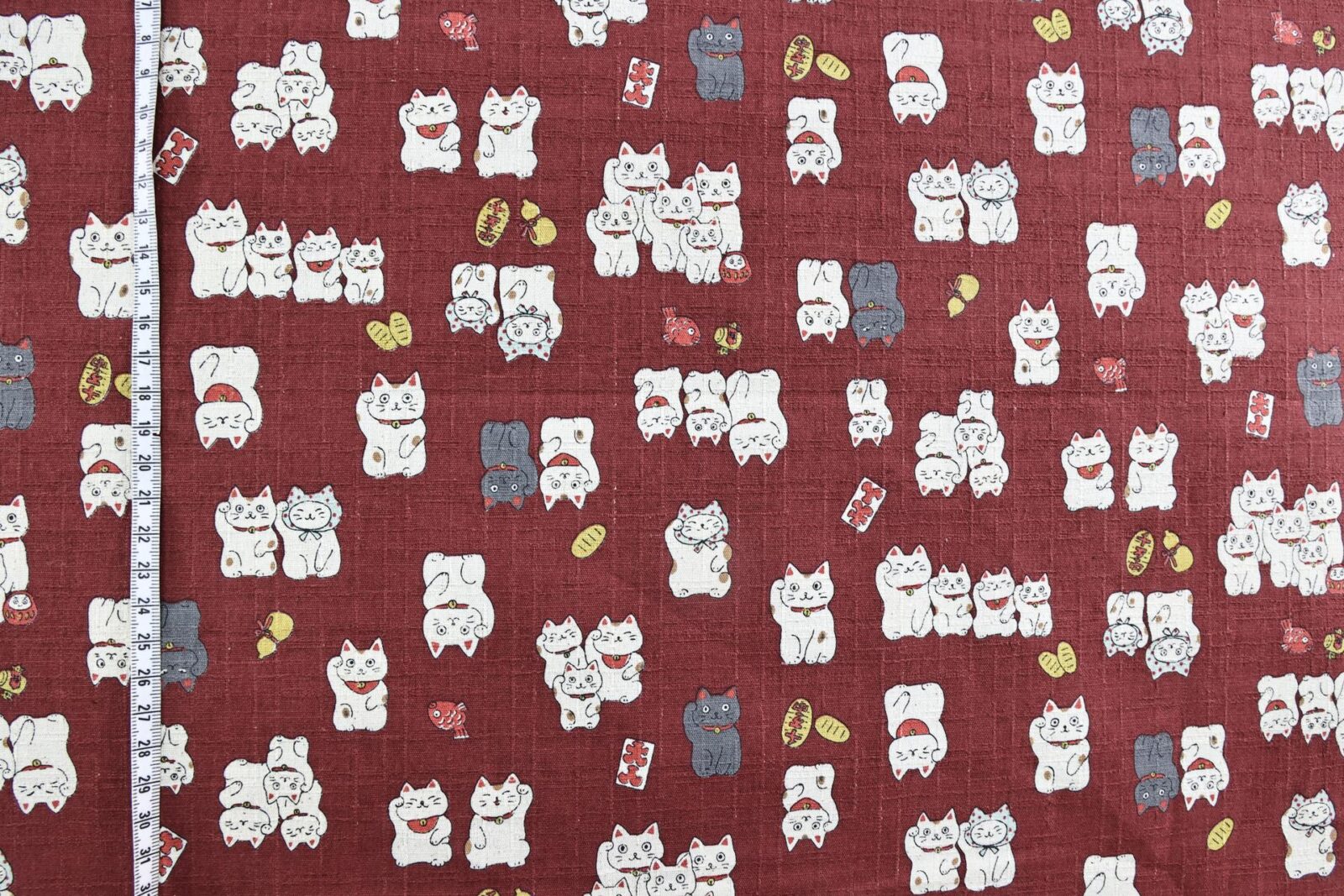 Japanese Maneki Neko dobby cotton fabric – red background