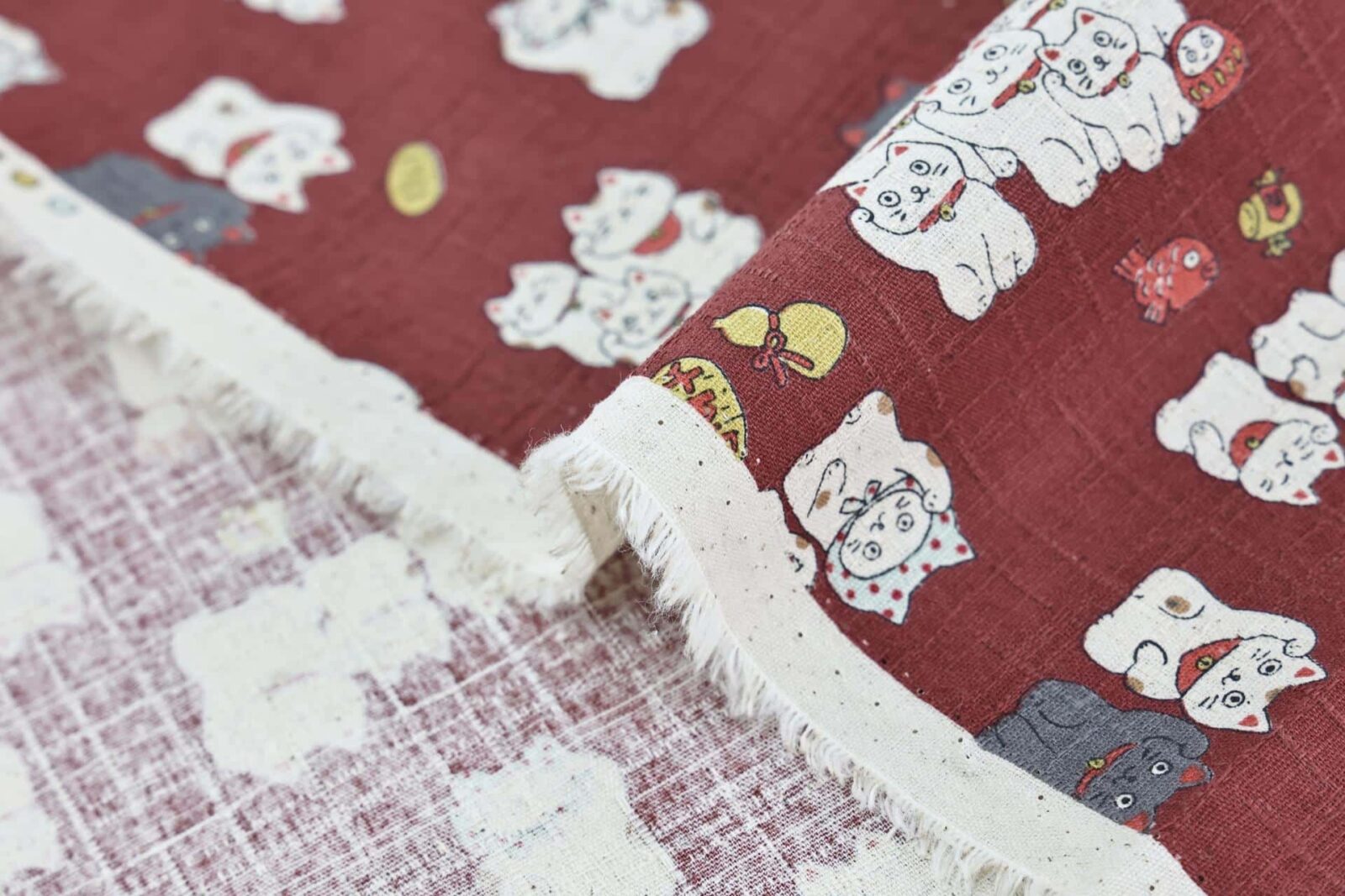Japanese Maneki Neko dobby cotton fabric – red background