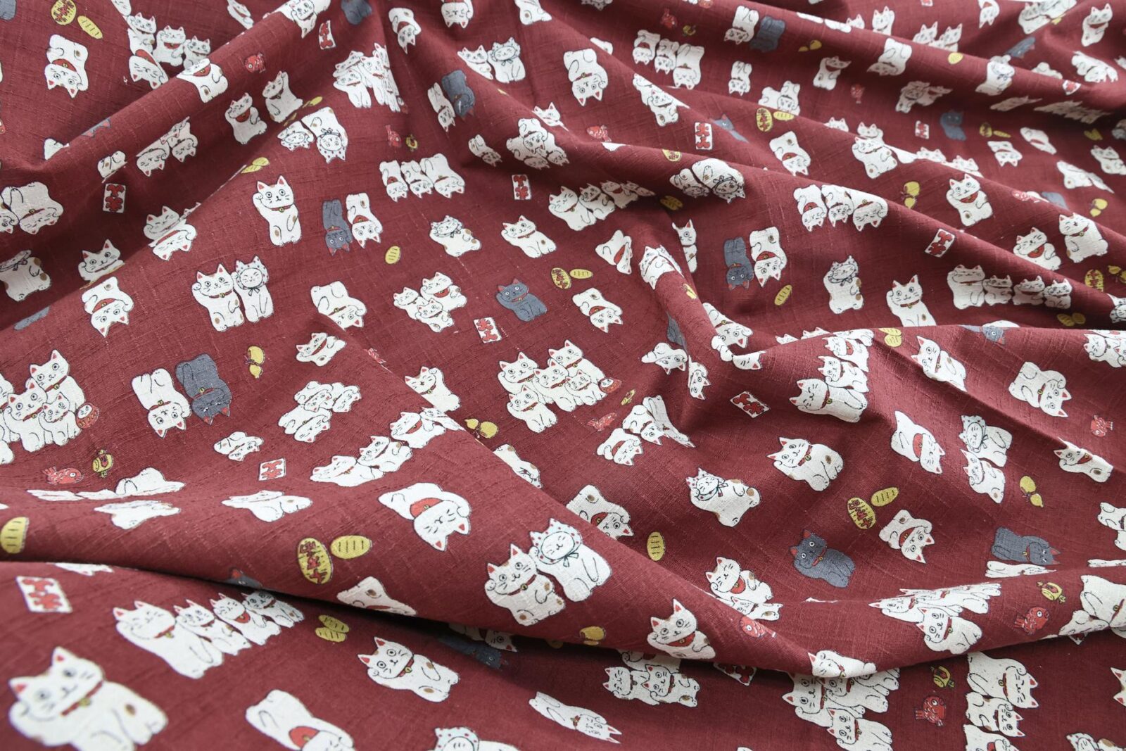 Japanese Maneki Neko dobby cotton fabric – red background