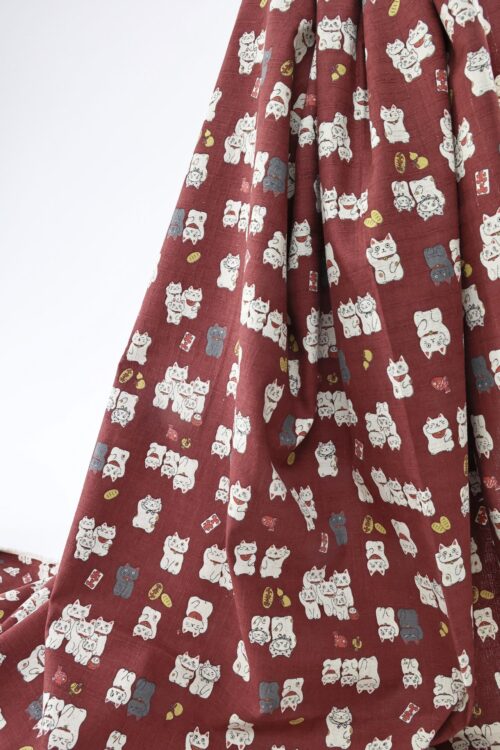 Japanese Maneki Neko dobby cotton fabric – red background