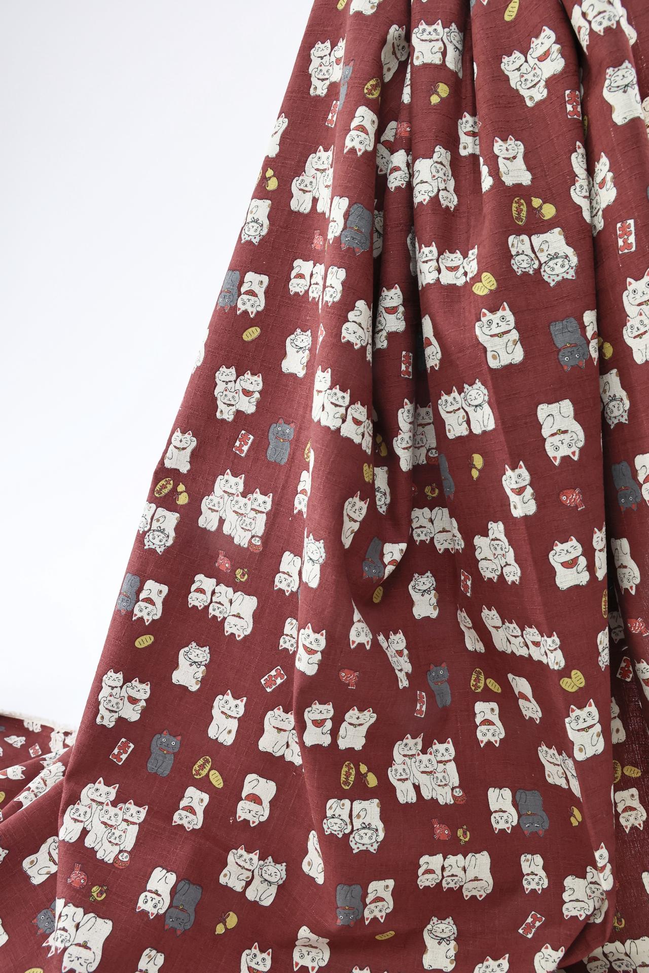 Japanese Maneki Neko dobby cotton fabric – red background
