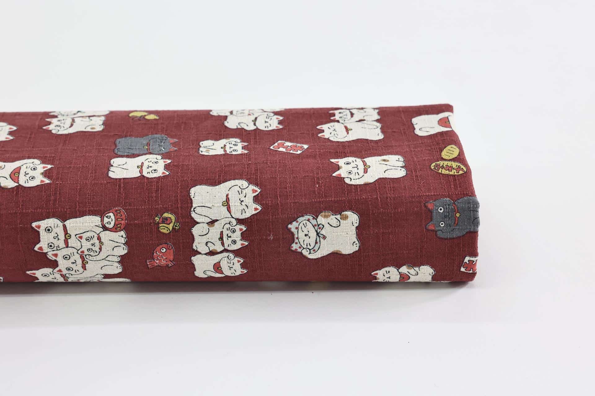 Japanese Maneki Neko dobby cotton fabric – red background