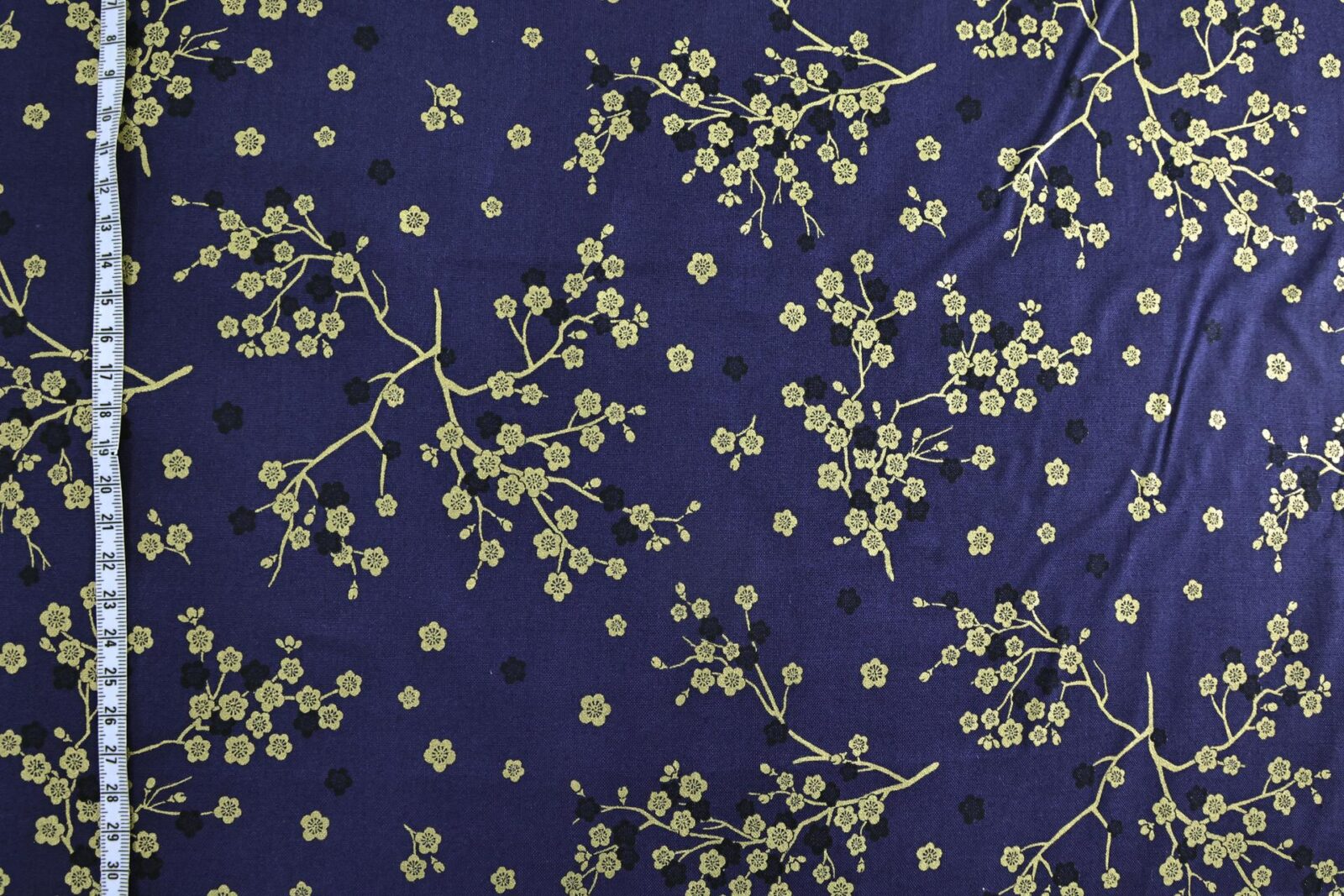 Japanese fabric golden plum blossoms blue background