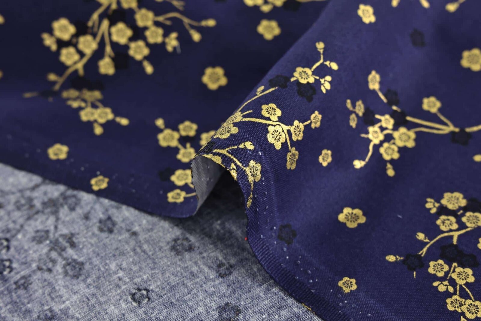 Japanese fabric golden plum blossoms blue background