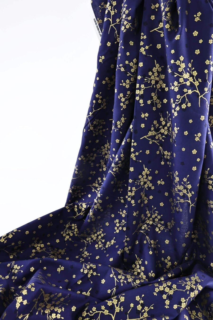 Japanese fabric golden plum blossoms blue background