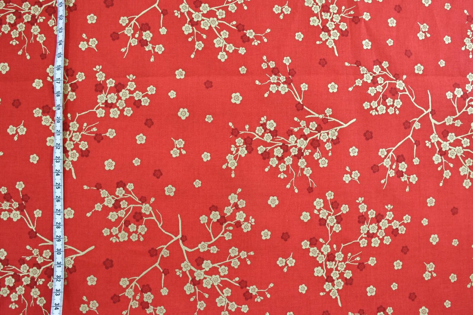 Japanese fabric golden plum blossoms red background