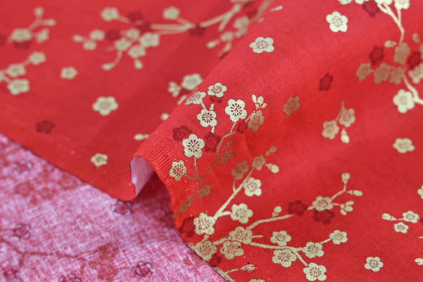 Japanese fabric golden plum blossoms red background