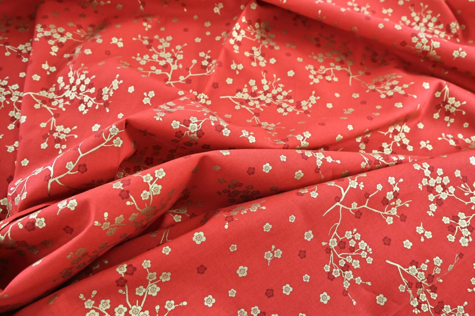 Japanese fabric golden plum blossoms red background