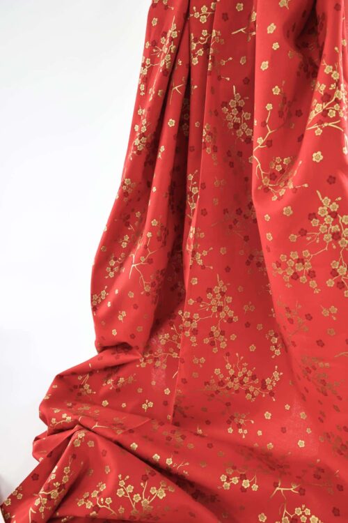 Japanese fabric golden plum blossoms red background