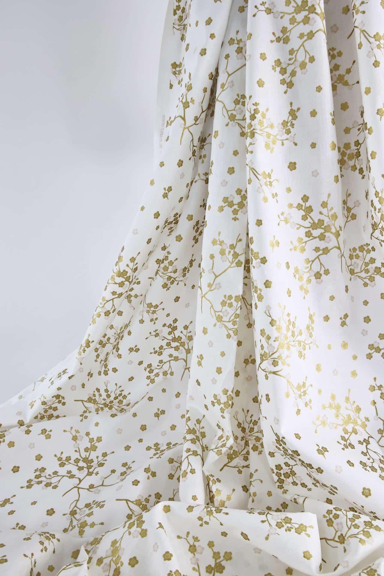 Japanese fabric golden plum blossoms white background
