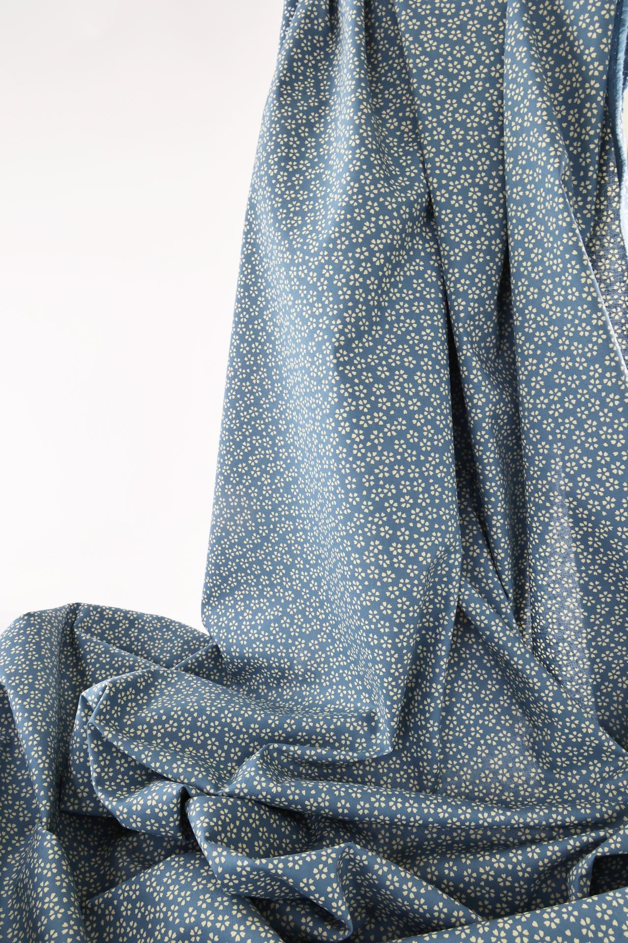 Sevenberry fabric ecru Sakura blue background