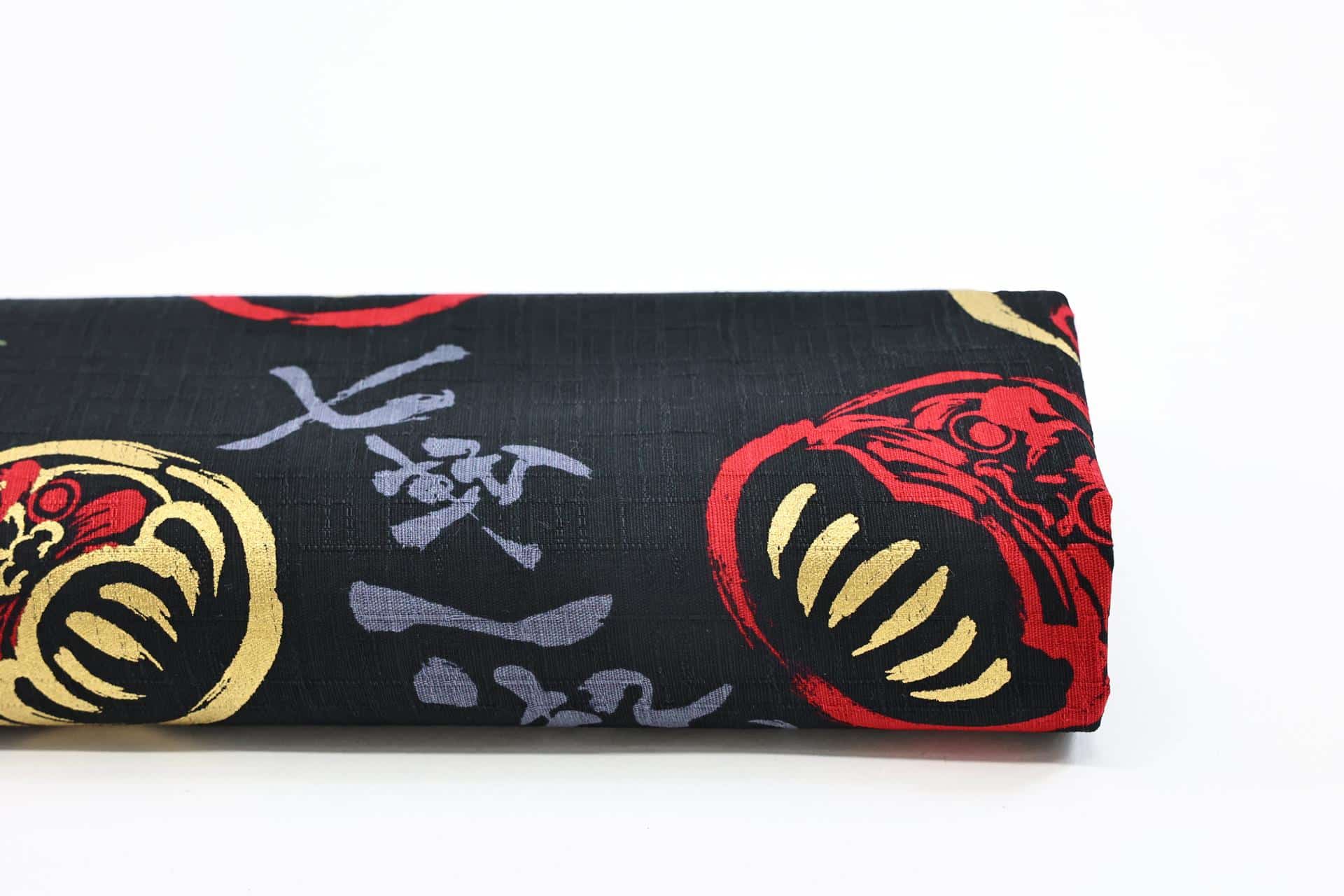 Japanese Daruma fabric on black background