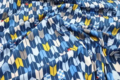 Japanese arrow feather yagasuri fabric in tonal indigo blue, crumpled flat