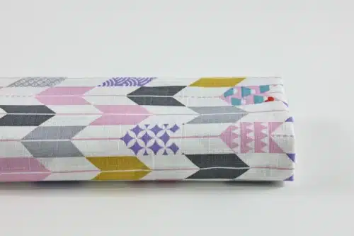 Japanese arrow feather yagasuri fabric pink and mauve on a white background