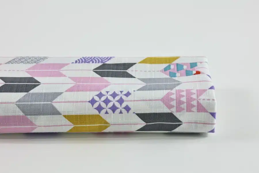Japanese arrow feather yagasuri fabric pink and mauve on a white background
