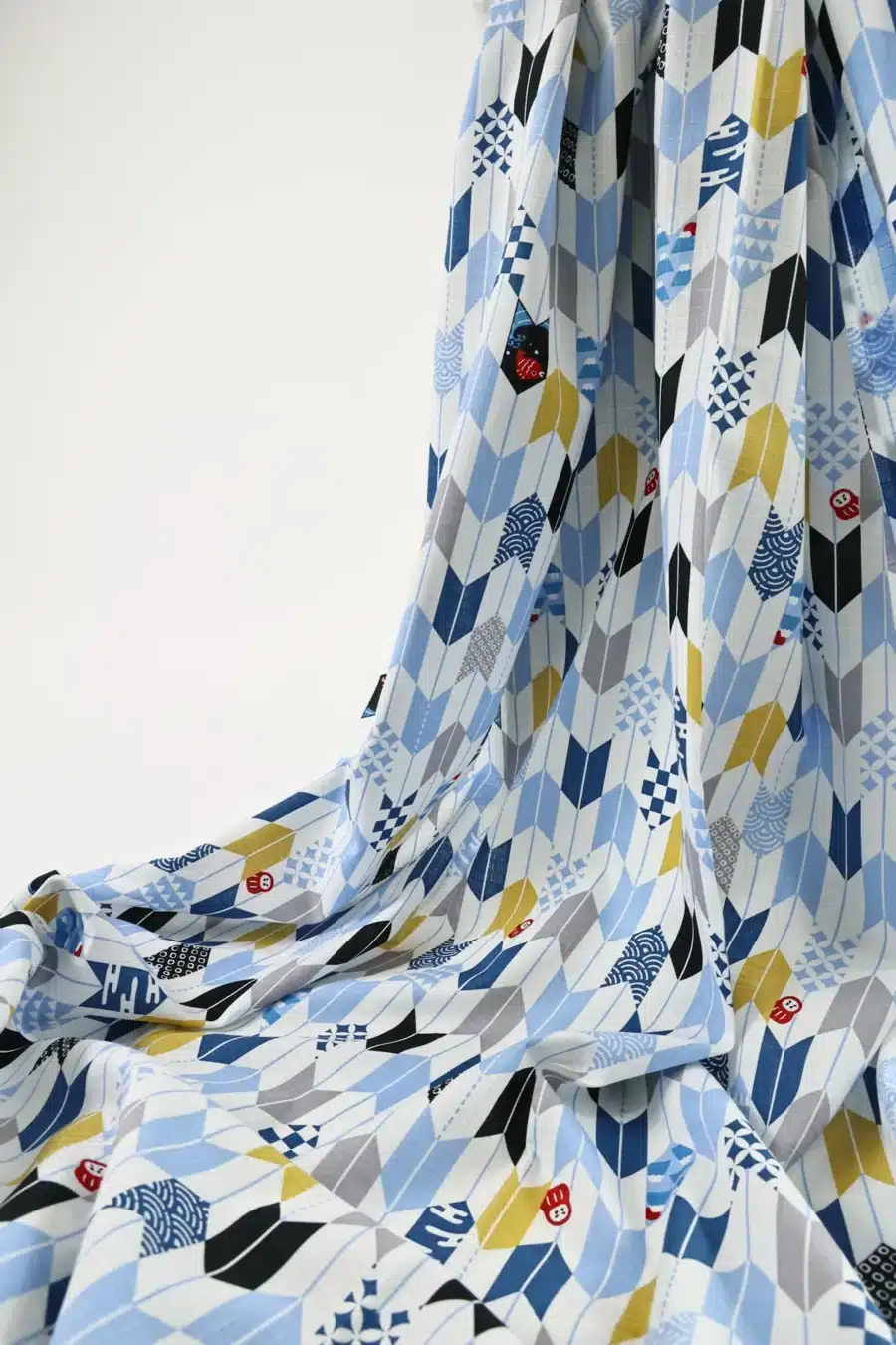 Japanese arrow feather yagasuri fabric multicolor on a white background, draped