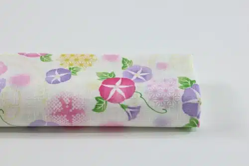 Japanese morning glory asagao fabric with pink and mauve flowers on an off-white background
