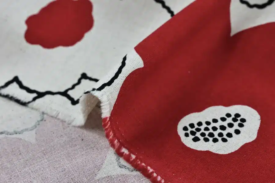 Tissu Japonais canvas fleurs rouges encre noire, canvas coton et lin Kobayashi, gros plan sur le pli et la lisière