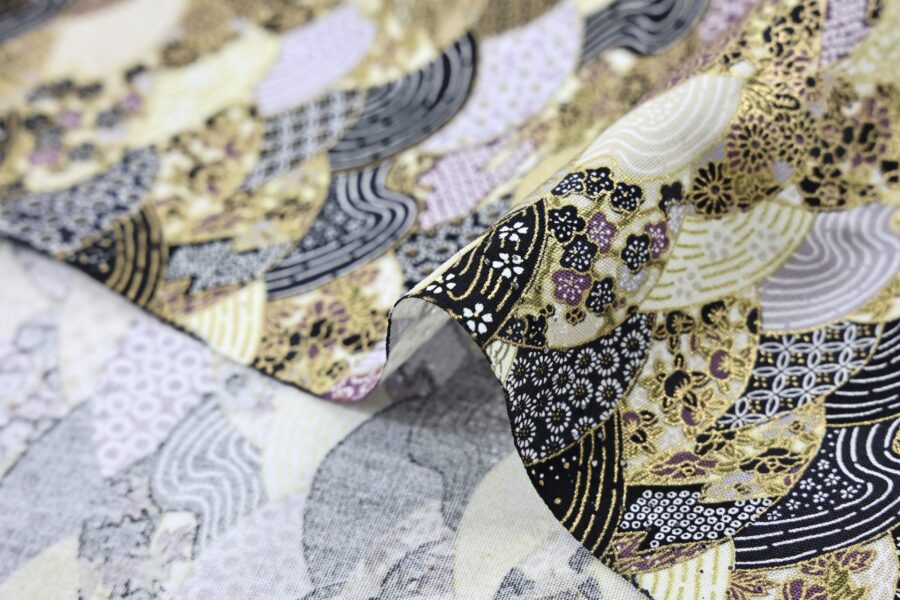 Tissu japonais vagues multi motifs traditionnels dorés, tons noir, or et mauve, gros plan sur le pli
