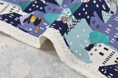 Japanese witch cat village fabric blue, Kobayashi cotton and linen canvas, close-up of fold and selvage