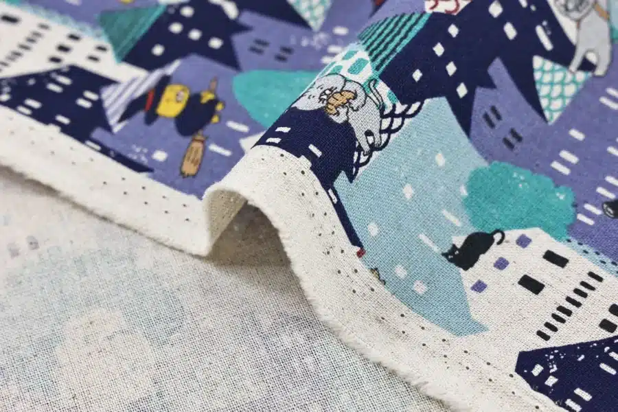 Japanese witch cat village fabric blue, Kobayashi cotton and linen canvas, close-up of fold and selvage