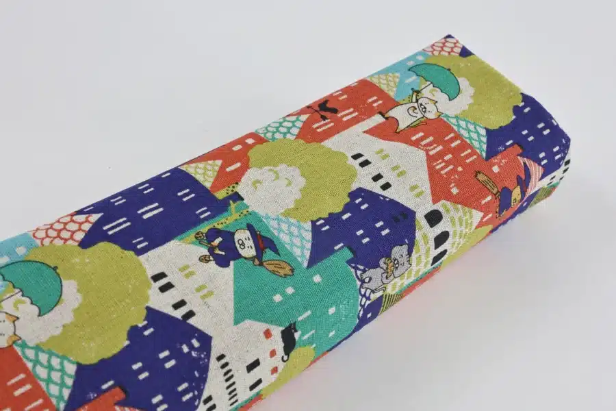 Japanese witch cat village fabric multicolor, Kobayashi cotton and linen canvas, fabric roll on white background