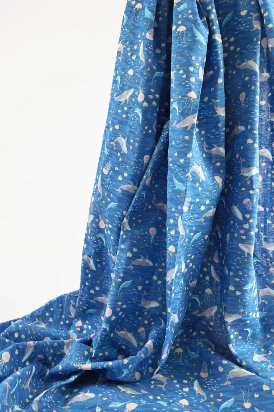Japanese double gauze whale and dolphin fabric blue background, fold with selvedge and reverse side