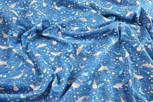 Japanese double gauze whale and dolphin fabric blue background, crumpled flat