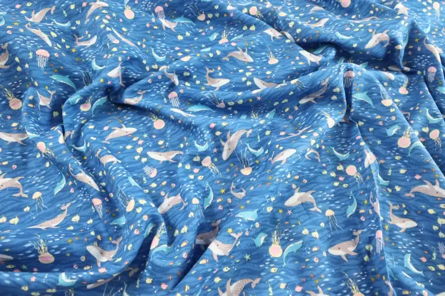 Japanese double gauze whale and dolphin fabric blue background, crumpled flat