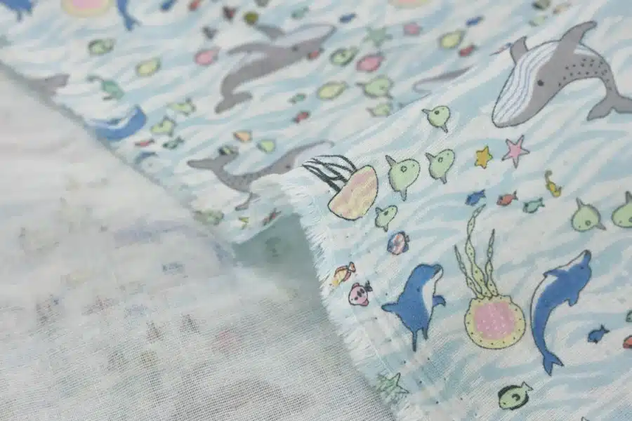 Japanese double gauze whale and dolphin fabric white background, fold with selvedge and reverse side