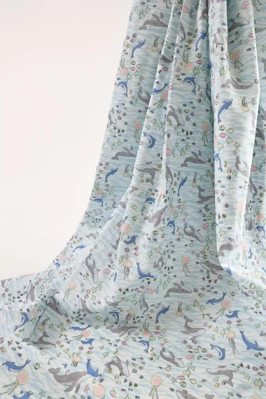 Japanese double gauze whale and dolphin fabric white background, draped