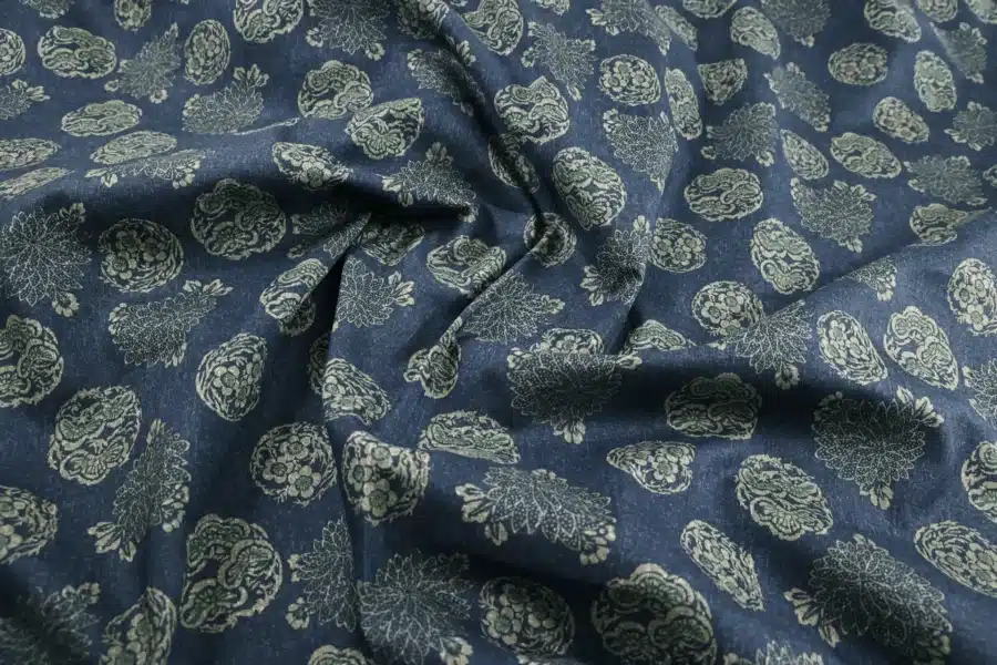 Japanese hanamaru floral medallions fabric navy blue background, draped