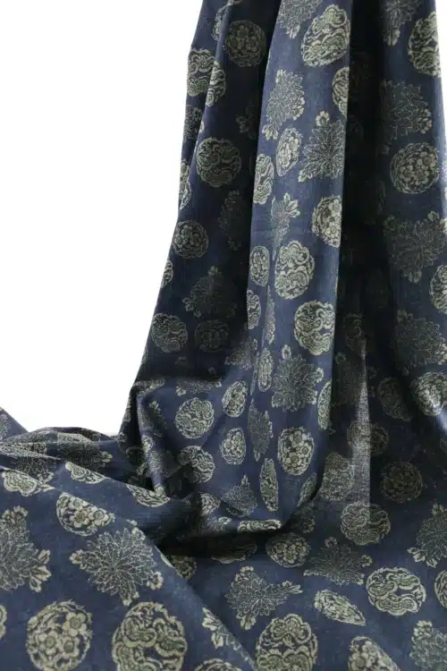 Japanese hanamaru floral medallions fabric navy blue background, draped folds
