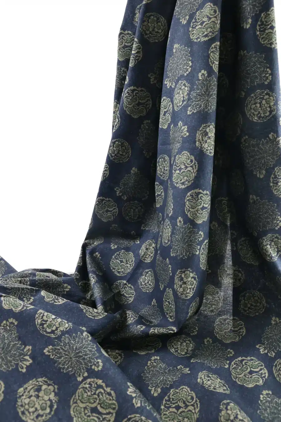 Japanese hanamaru floral medallions fabric navy blue background, draped folds